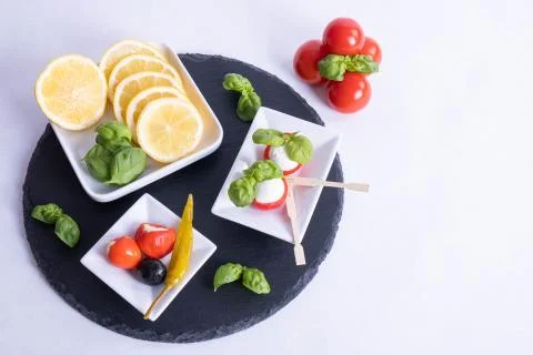 Healthy breakfast on the table, basil, mozzarella in red tomatoes Stock Photos