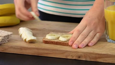 Healthy breakfast is toast with peanut paste and bananas Stock Footage 155571275