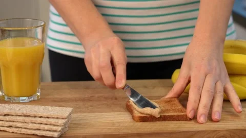 Healthy breakfast is toast with peanut paste and bananas Stock Footage 155571469
