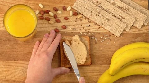 Healthy breakfast is toast with peanut paste and bananas Stock Footage 155571936