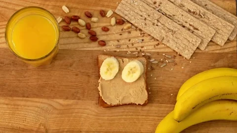 Healthy breakfast is toast with peanut paste and bananas Stock Footage 155571945