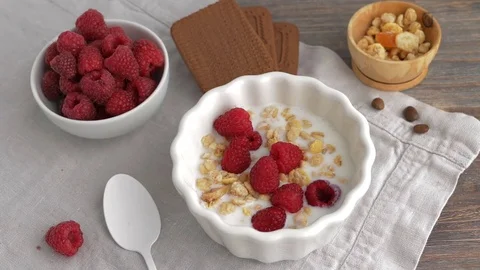 Healthy breakfast - yogurt or milk with rberries, cereals or gorp, cakes. Stock Footage