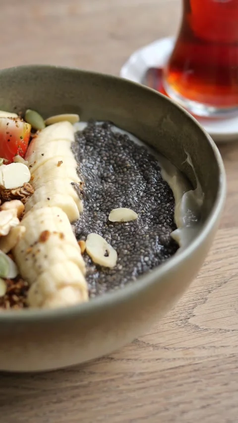 Healthy chia seed pudding with fresh fruits and nuts on wooden table, close.. Stock Footage 332113569