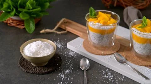 Healthy Chia Seed Pudding with Mango and Shredded Coconut in Glass Cups Stock Photos