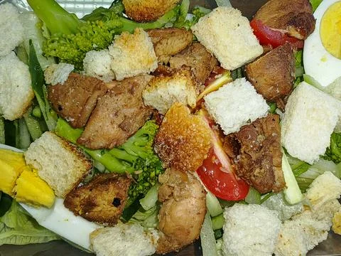 Healthy Chicken Caesar Salad with Broccoli, Croutons, and Boiled Eggs Stock Photos