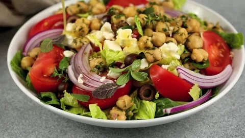 Healthy chickpea and vegetable salad with dressing Stock Footage 242524670