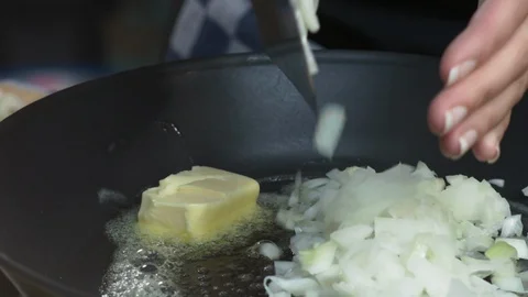Healthy Cooking: Adding Fresh Chopped Onions To Melted Butter in A Frying Pan 스톡 동영상 118569112