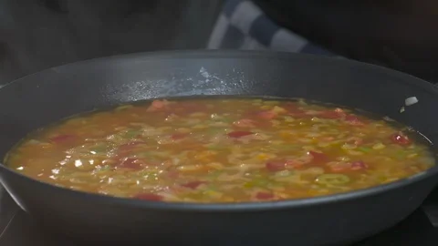 Healthy Cooking Adding Salt To Frying Pan with Ingredients Onions Pepper Leek 스톡 동영상 118569689