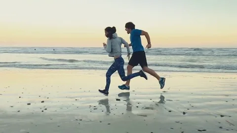 Healthy couple training on beach slow motion Stock Footage 76520283