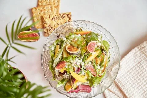 Healthy dinner, mediterranean salad of fresh arugula, grain rustic cheese Stock Photos