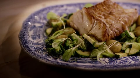 Healthy dish, grilled cod with vegetables and pine nuts Stock Footage 47034710