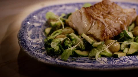 Healthy dish, grilled cod with vegetables and pine nuts Stock Footage 47051801