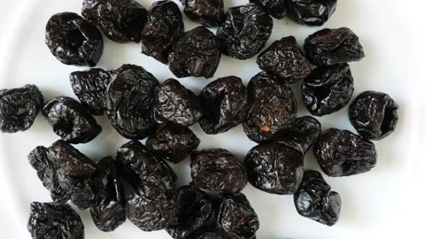 Healthy dried prunes rotating on a white background Stock Footage 337011909