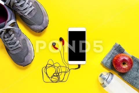 Healthy eating and equipment for leisure and outdoor sports, on yellow backgr Stock Photos