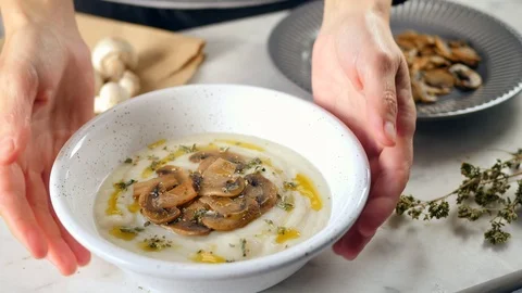 Healthy eating, serving mushroom soup in a bowl. take off the table a bowl  Stock Footage 124895341