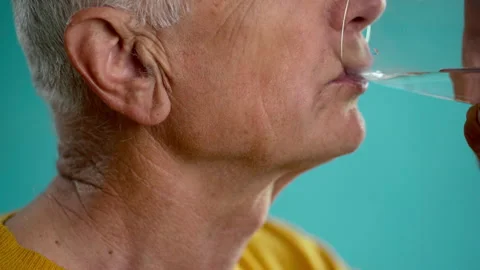 Healthy elderly man drinking fresh transparent mineral water, old man hydrating Stock Footage 274432962