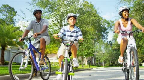 Healthy Ethnic Family Bike Riding Together Stock Footage