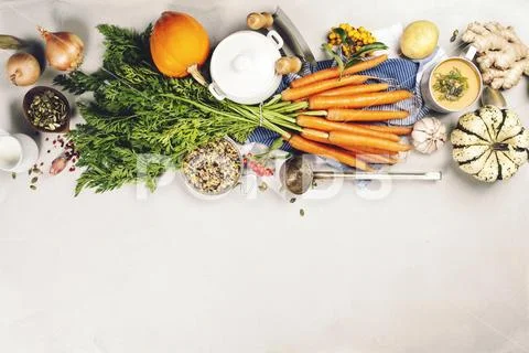 Healthy food cooking background. Fresh garden carrots, onions, pumpkins, ginger Stock Photos