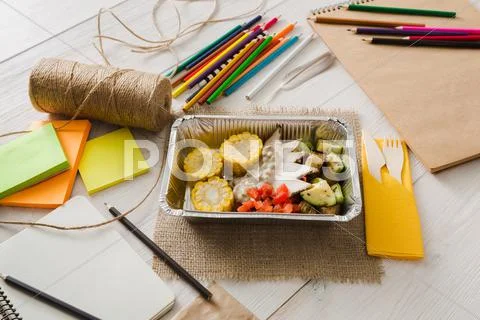 Healthy food in foil box on working table, diet concept Stock Photos