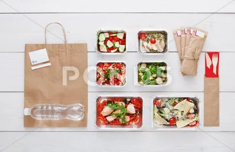 Healthy food take away in boxes, top view at wood Stock Photos