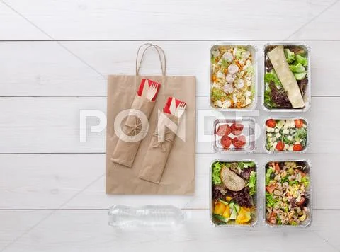 Healthy food take away in boxes, top view at wood Stock Photos