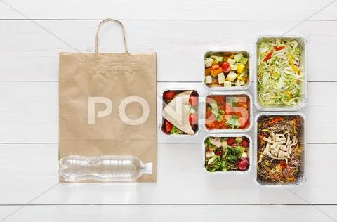 Healthy food take away in boxes, top view at wood Stock Photos