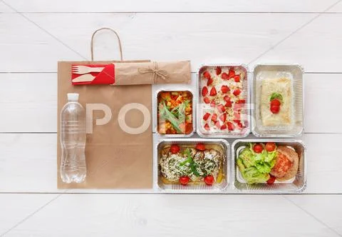 Healthy food take away in boxes, top view at wood Stock Photos
