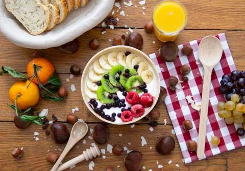 Healthy fresh breakfast with bread yoghurt fruits juice and nuts on wood table Stock Photos