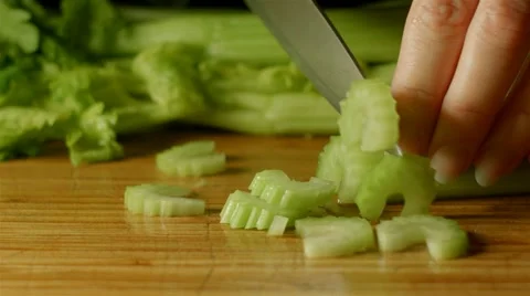 Healthy fresh celery food prep cutting up of vegetables and fruit in kitchen Stock Footage 48083287