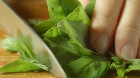 Healthy fresh green basil food prep cutting up in kitchen Stock Footage