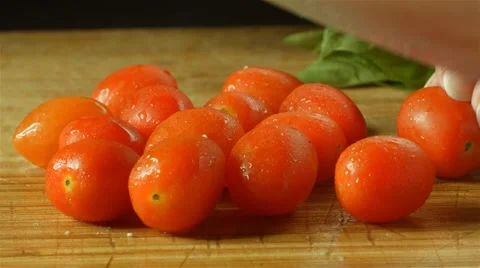 Healthy fresh red tomatoes prep cutting up of vegetables and fruit in kitchen Stock Footage 48098884