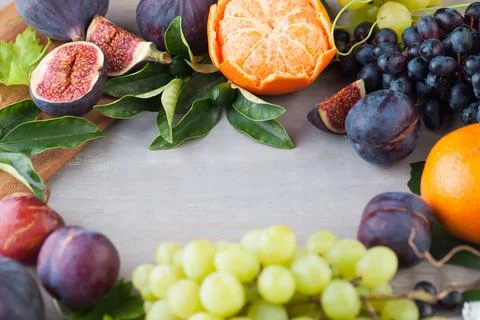 Healthy fruit background border frame on gray wood board. Organic food Stock Photos