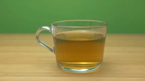 Healthy green tea on wooden table green screen background zoom to the right Stock Footage