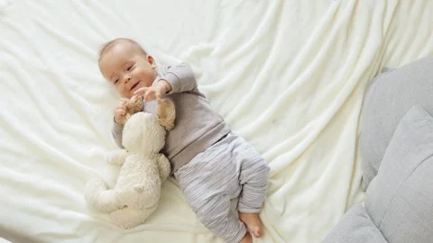 Healthy growth and playful development. Top view of cute newborn boy lying Stock Footage 291154953