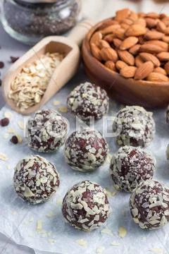 Healthy homemade paleo chocolate energy balls on parchment, vertical Stock Photos