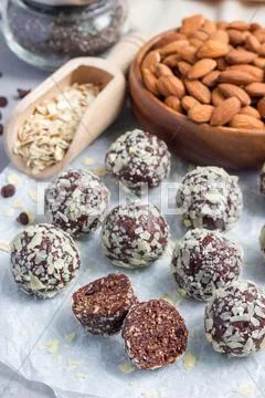Healthy homemade paleo chocolate energy balls on parchment, vertical Stock Photos