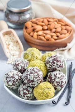 Healthy homemade paleo chocolate energy balls on plate, vertical Stock Photos