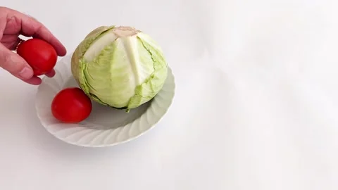 Healthy Kitchen Prep- Cabbage and Tomatoes Styled on Plate Stock Footage 316668781