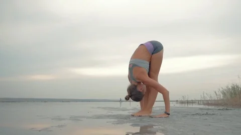 Healthy life exercise concept - Young sporty fit woman doing yoga Sun salutation Stock Footage
