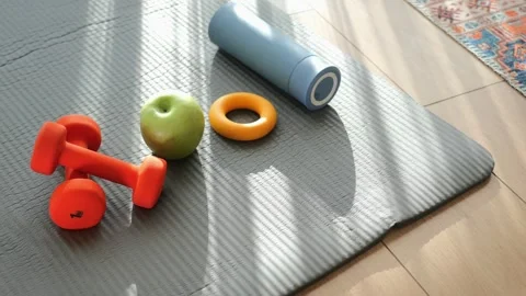 Healthy lifestyle objects on yoga mat with sunlight rays dynamic motion. Stock Footage 332116314