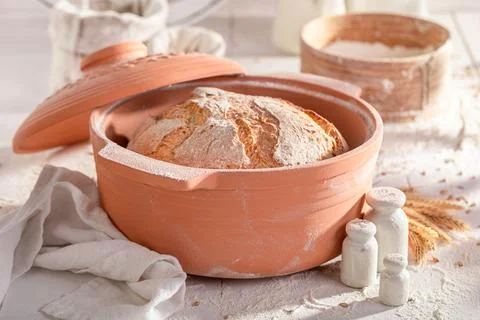Healthy loaf of bread in a ceramic baking tin. Stock Photos
