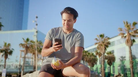 Healthy-looking sports guy using smartphone to stay connected in social media Stock Footage 109419252