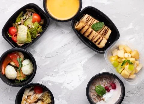 Healthy lunch box in plastic boxes, pumpkin cream soup, quail eggs and vegeta Stock Photos