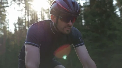 Healthy man doing exercise riding a bicycle outdoors early in the morning Stock Footage 74548545