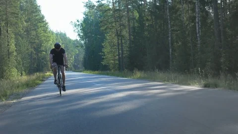 Healthy man doing exercise riding a bicycle in nature Video stock 74550337
