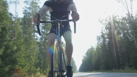 Healthy man doing exercise riding a bicycle in nature Stock Footage 74551181