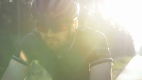 Healthy man doing exercise riding a bicycle outdoors early in the morning Stock Footage 75399118