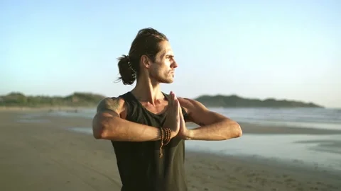 Healthy man exercising on beach, practicing Qi gong,  yoga. social distancing Stock Footage 186936051