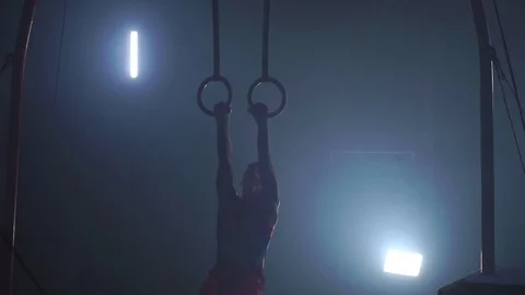 Healthy man training gymnastics exercise using rings enjoying intense fitness Stock Footage 100963430