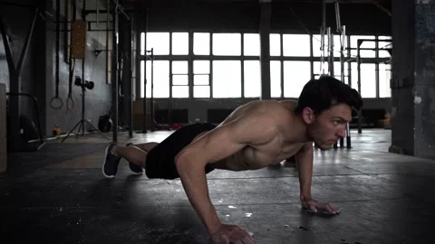 Healthy man training push ups exercise intense muscle workout in gym 動画素材 131218109